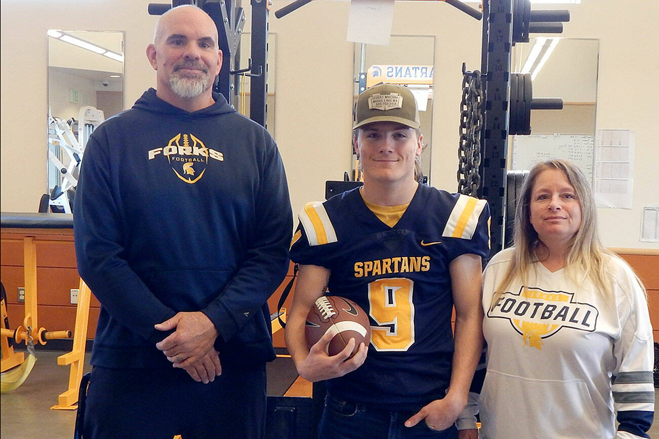 Christi Baron/Olympic Peninsula News Group
Forks' Dalton Kilmer, center, is one of five North Olympic Peninsula athletes who will play for the West team in the Class 2A/1A/B Earl Barden Classic, the all-state football game, in Yakima on Saturday. Kilmer is joined by Forks football coach Trevor Highfield and his mom, Amy Kilmer.