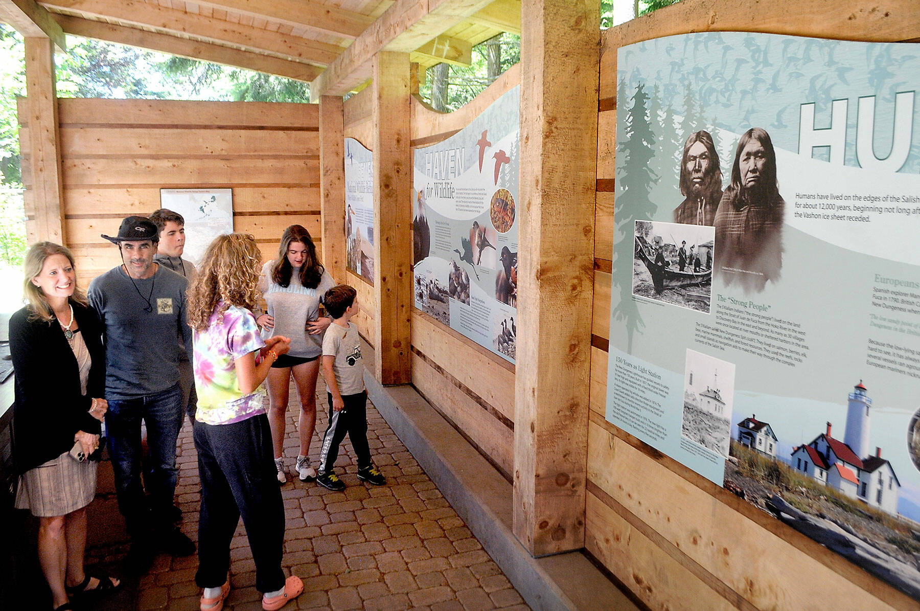 Members of the Polge family from Raleigh, N.C., from left, parents Tami and Steven, and siblings Sebastian, 18, Anna, 15, Christina, 18, and Nico, 7, exmaine an informational display at the Dungeness National Wildlife Refuge north of Sequim on Thursday. (Keith Thorpe/Peninsula Daily News)