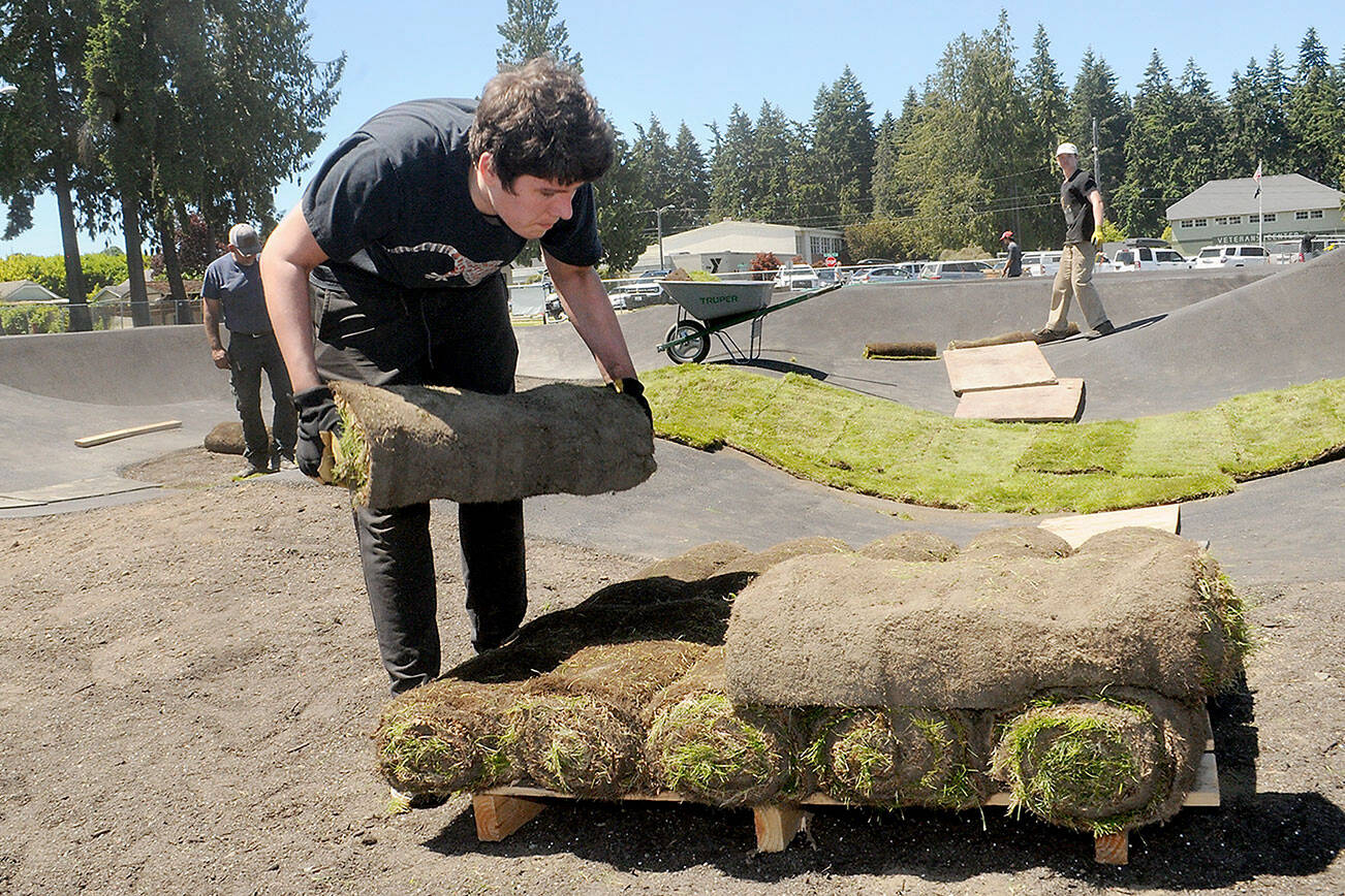 Keith Thorpe/Peninsula Daily News
Volunteer Eric Lalonde, 15, of Port Angeles carries a roll of sod during a community work day on Friday at the pump track being built at Erickson Playfield in Port Angeles. The track, designed primarily for bicycles and other wheeled play vehicles, is being constructed by the Port Angeles Parks & Recreation Department in conjunction the Lincoln Park BMX Association with funding from a $350,000 grant from the state Recreation and Conservation Office, $100,000 in lodging tax grants from the city and Clallam County, business sponsorships, individual and community donations and a grant from the Christopher and Dana Reeve Foundation. Organizers have scheduled a grand opening for the facility for 5:30 p.m. on July 6.