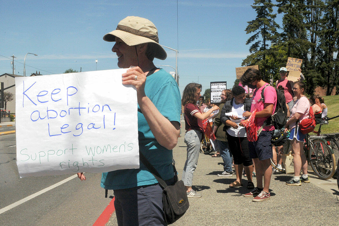 Carole Scholl of Port Angeles shows her support for women’s rights during a rally Saturday following the U.S. Supreme Court’s decision to overturn Roe v. Wade. For more on the rallies in Port Angeles, Sequim and Port Townsend, see Monday’s print and online editions. (Keith Thorpe/Peninsula Daily News)