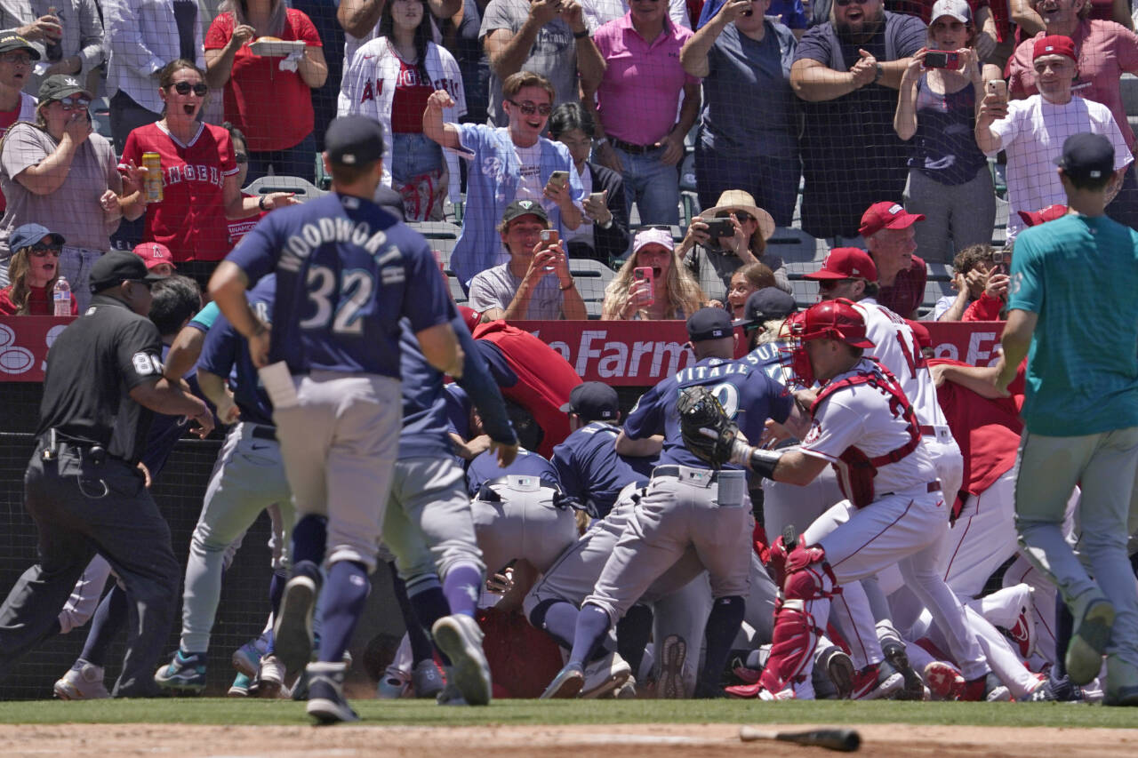 Several members of the Seattle Mariners and the Los Angeles Angels scuffle after Mariners' Jesse Winker was hit by a pitch during the second inning of a baseball game Sunday, June 26, 2022, in Anaheim, Calif. (AP Photo/Mark J. Terrill)