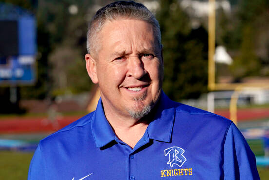 Joe Kennedy, a former assistant football coach at Bremerton High School, poses for a photo March 9, 2022, at the school’s football field. The Supreme Court has sided with a football coach who sought to kneel and pray on the field after games. The court ruled 6-3 along ideological lines, saying the coach’s prayer was protected by the First Amendment. (Ted S. Warren/The Associated Press)