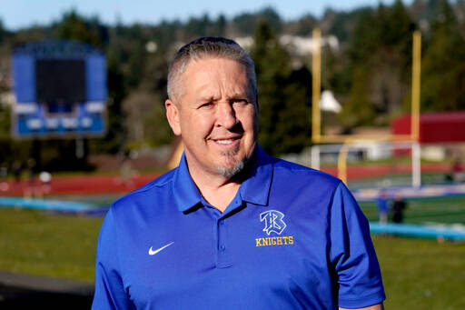 Joe Kennedy, a former assistant football coach at Bremerton High School, poses for a photo March 9, 2022, at the schools football field. The Supreme Court has sided with a football coach who sought to kneel and pray on the field after games. The court ruled 6-3 along ideological lines, saying the coachs prayer was protected by the First Amendment. (Ted S. Warren/The Associated Press)