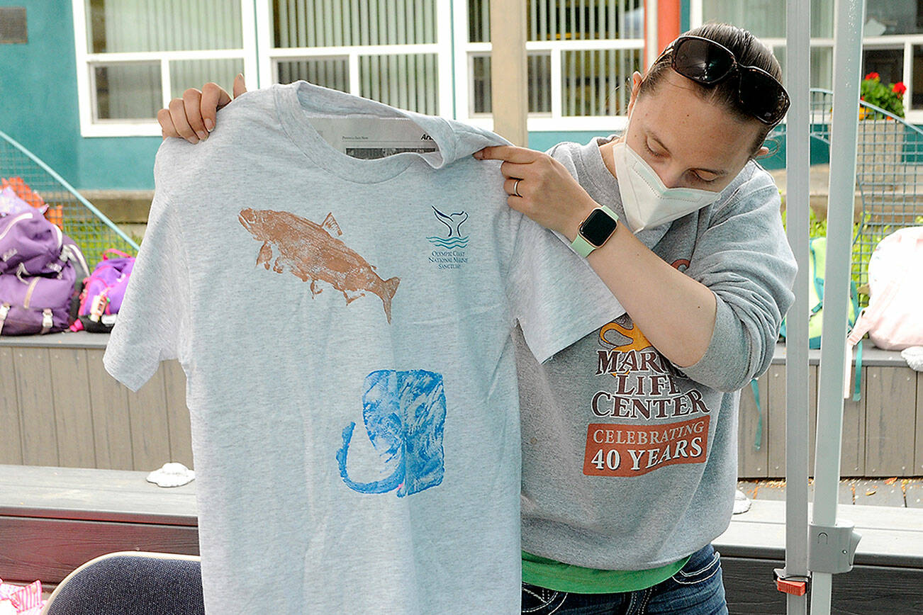 KeithThorpe/Peninsula Daily News
Rachele Brown, education manager for Feiro Marine Life Center in Port Angeles, displays a fish print shirt she had just created during the seasonal Junior Oceanographer summer camp for youngsters. The camps, which are sold out for the summer season, are designed for children to learn more about marine life and are held in conjunction with the Olympic Coast National Marine Sanctuary.