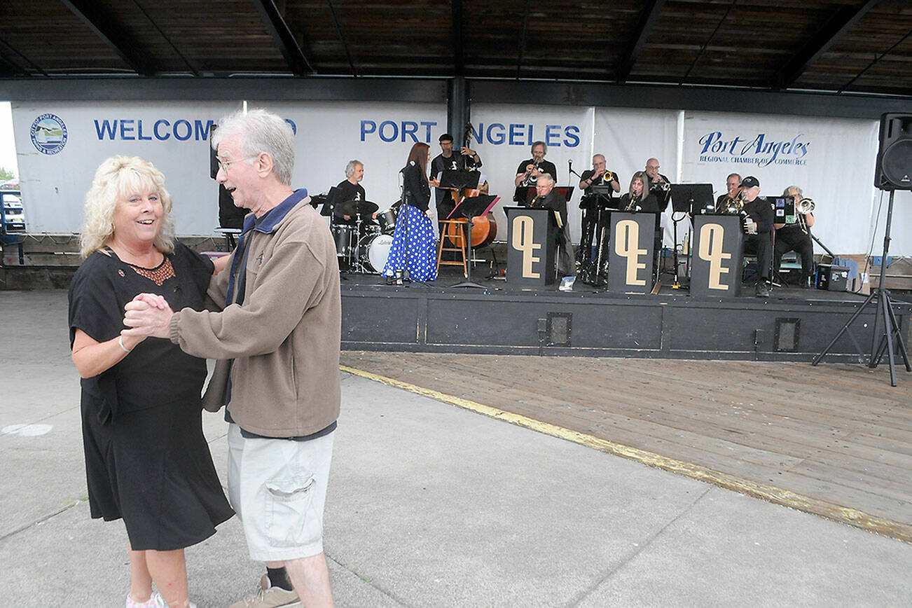 Keith Thorpe/Peninsula Daily News
Freia Palmer of Port Angeles and Tom Cox of Port Townsend dance to the music of Olympic Express Big Band during Wednesday night's kickoff show in the Concerts on the Pier music series at Port Angeles City Pier. The free summer music series, hosted by the Juan de Fuca Foundation for the Arts and sponsored by Erika Ralston Word Windemere Real Estate, D.A. Davidson & Co., Elwha River Casino, Washington State Department of Commerce and the Peninsula Daily News, continues at 6 p.m. next Wednesday with the classic rock of Sweet Justice.