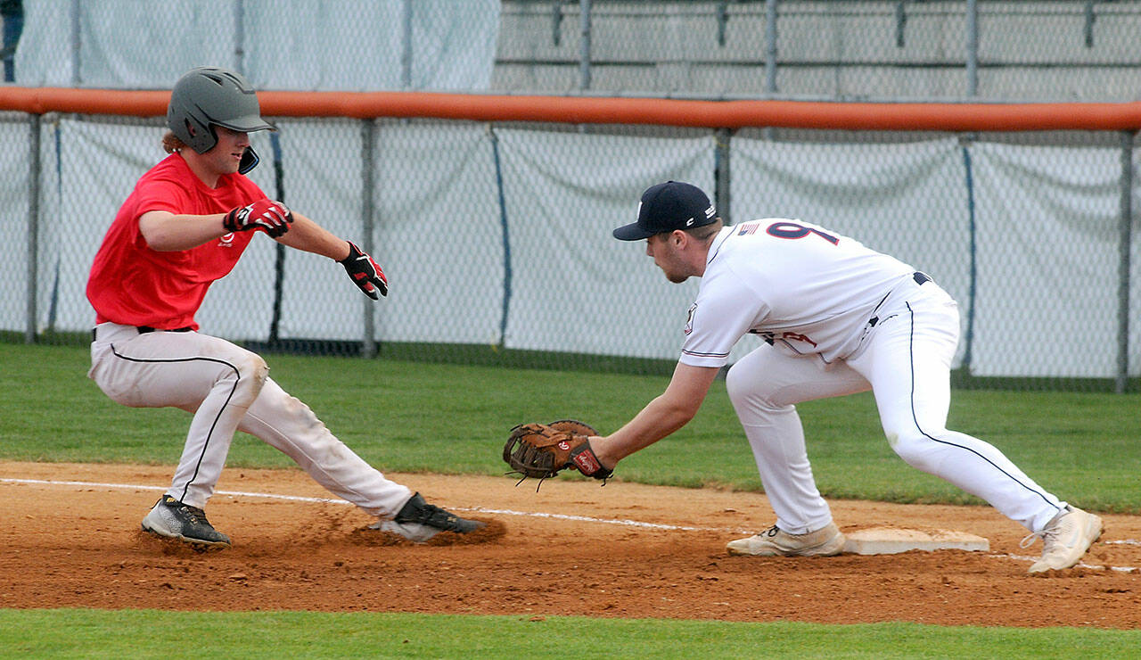 Keith Thorpe/Peninsula Daily News WBS Colts Red baserunner Bridger Bird gets caught off the bag as Wilder Senior first baseman Ezra Townsend starts to chase him down for the eventual out in the second inning on Thursday night’s opening rounds of the Dick Brown Memorial Firecracker Tournament at Port Angeles Civic Field.