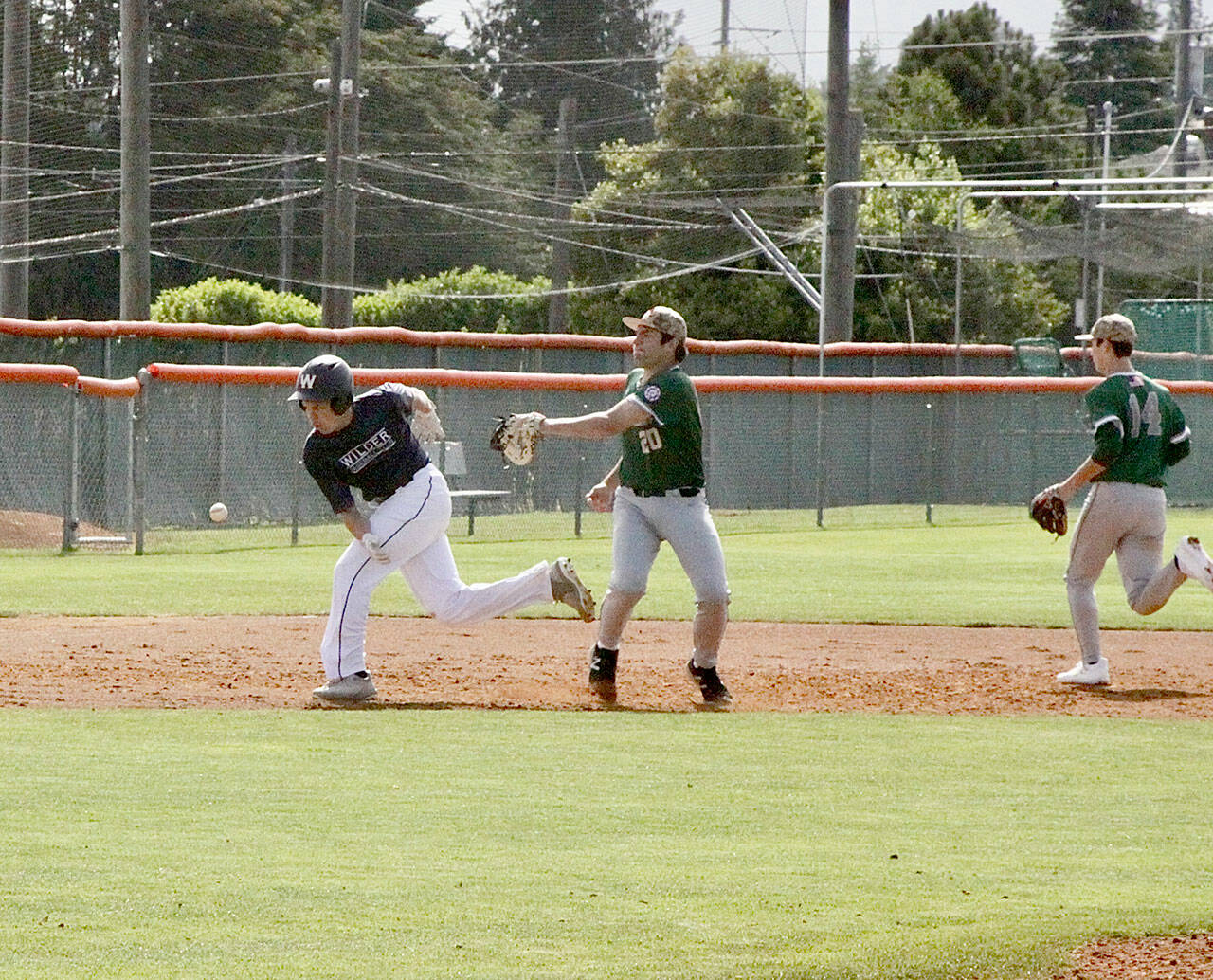 Kaleb Mullen of the Wilder Jr baseball team is in a pickle between 2nd and 3rd. But an errant through by the Lakeside team made it possible for Mullen to reach 3rd base safely. #20 is Luca Migliore and #14 is Jacob Freer for Lakeside of Issaquah. dlogan