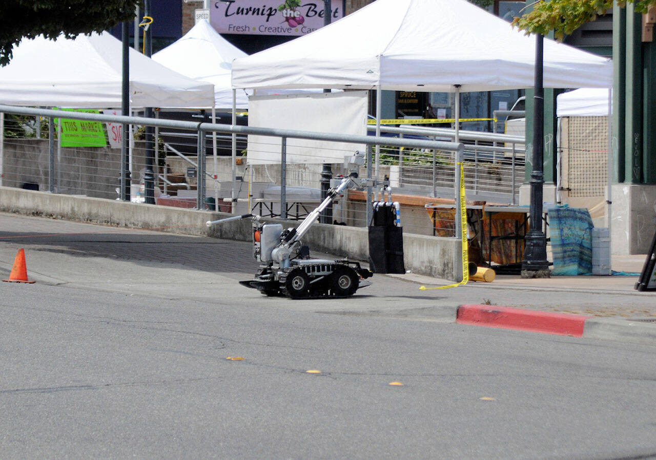 A Washington State Patrol bomb squad robot enters the Port Angeles Farmers Market at The Gateway to investigate a suspicious package found on Saturday. (Keith Thorpe/Peninsula Daily News)