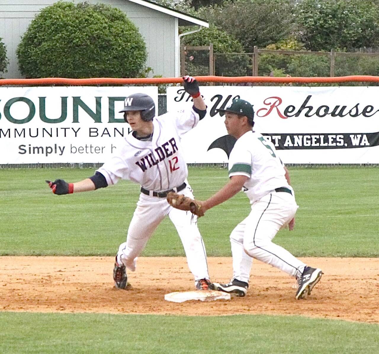 Wilder Seniors Landon Seibel looks back at the umpire as he is called safe at second base as Lakeside BRs Ethan Babauta puts the tag on Seibel on Sunday in the Dick Brown Memorial Tournament semifinal. Wilder Senior won 15-5 to advance to the championship game, which was won by WBC Colts Black. (Dave Logan/for Peninsula Daily News)
