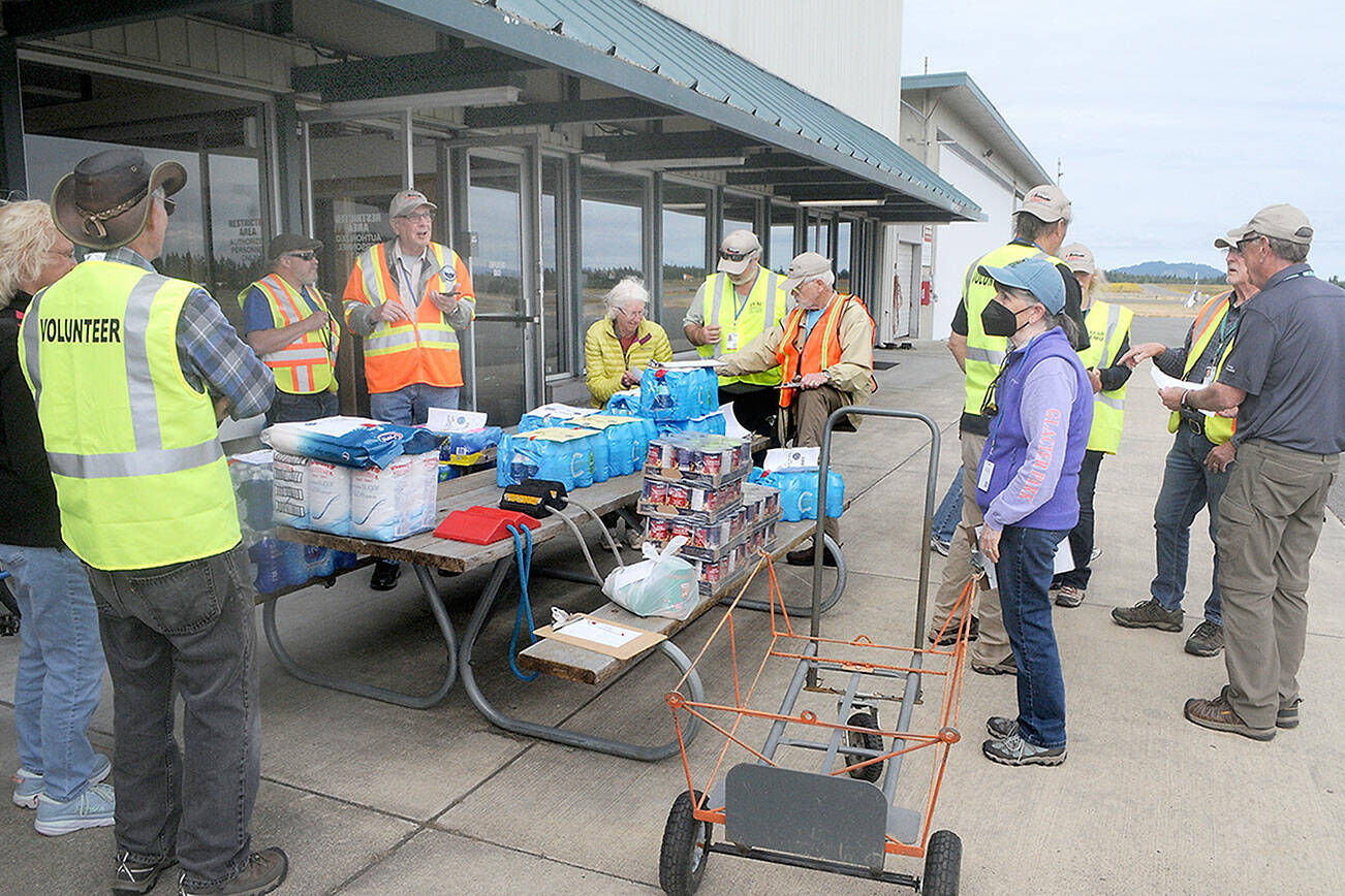 Clallam County Disaster Airlift Response Team members assemble food and water for a training session on Saturday at William R. Fairchild International Airport in Port Angeles that sent food supplies to five smaller airports across the county. (Keith Thorpe/Peninsula Daily News)