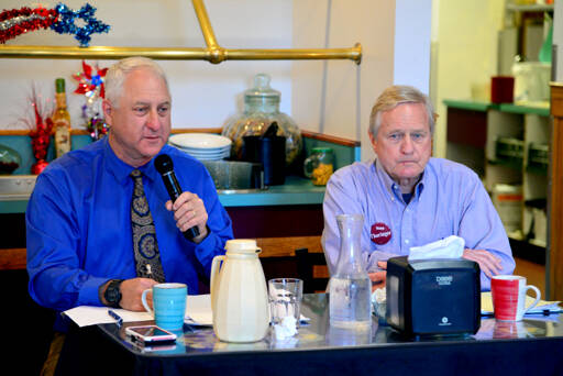 Brian Pruiett, a Republican candidate for state House of Representatives District 24, Position 2, left, speaks during a candidate debate at Joshua’s Restaurant in Port Angeles on Tuesday. Pruiett is challenging incumbent Steve Tharinger, a Democrat who’s held the seat since 2010, seated at right. (Peter Segall/Peninsula Daily News)