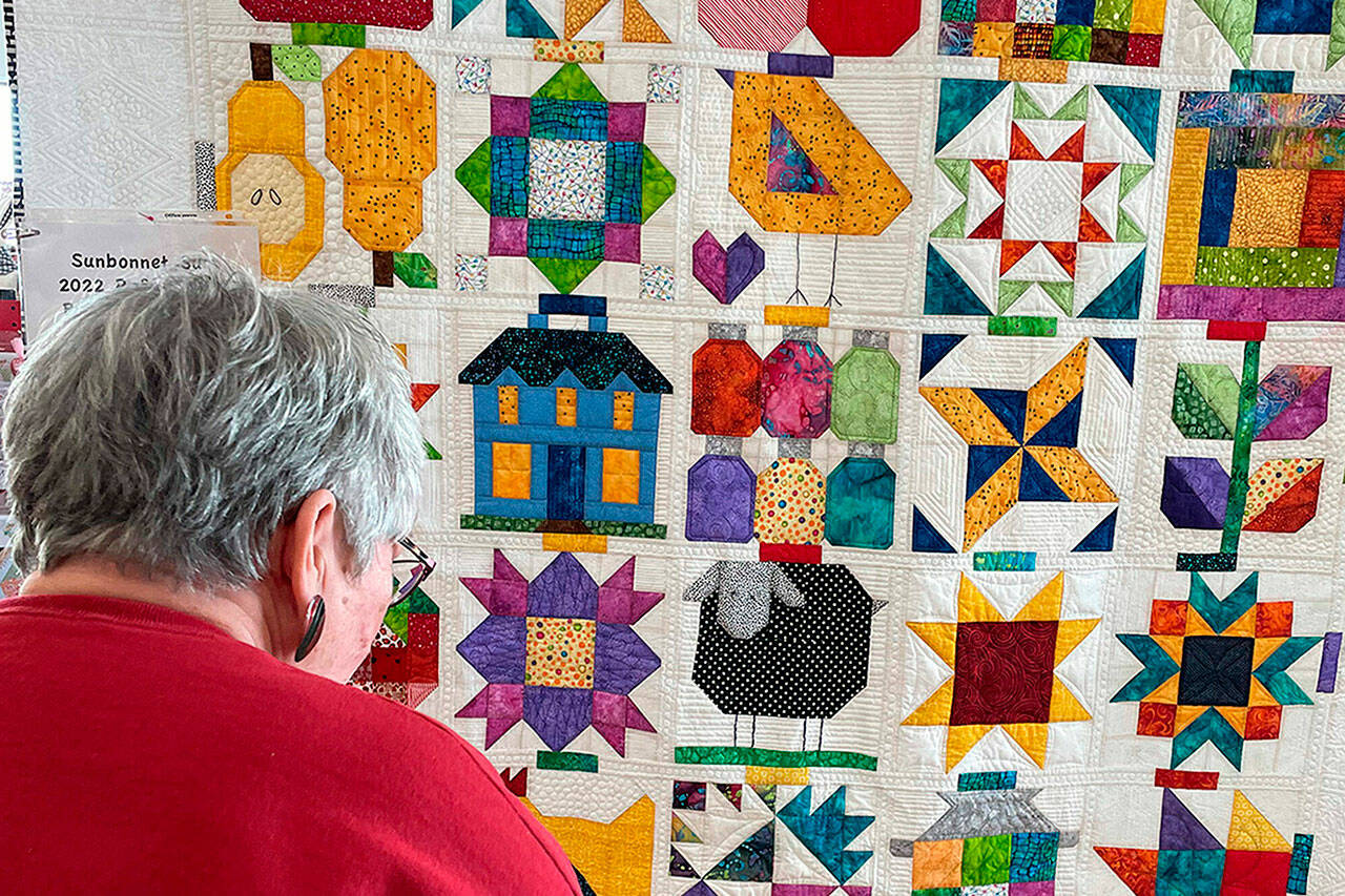 Matthew Nash / Olympic Peninsula News Group
“Down on the Farm” was pieced together by Bonnie Filgo, pictured, quilted by Dory Miller and finished by Bonnie Cauffman. It will be on display at the Sunbonnet Sue Quilt Show on Saturday at Pioneer Memorial Park.
