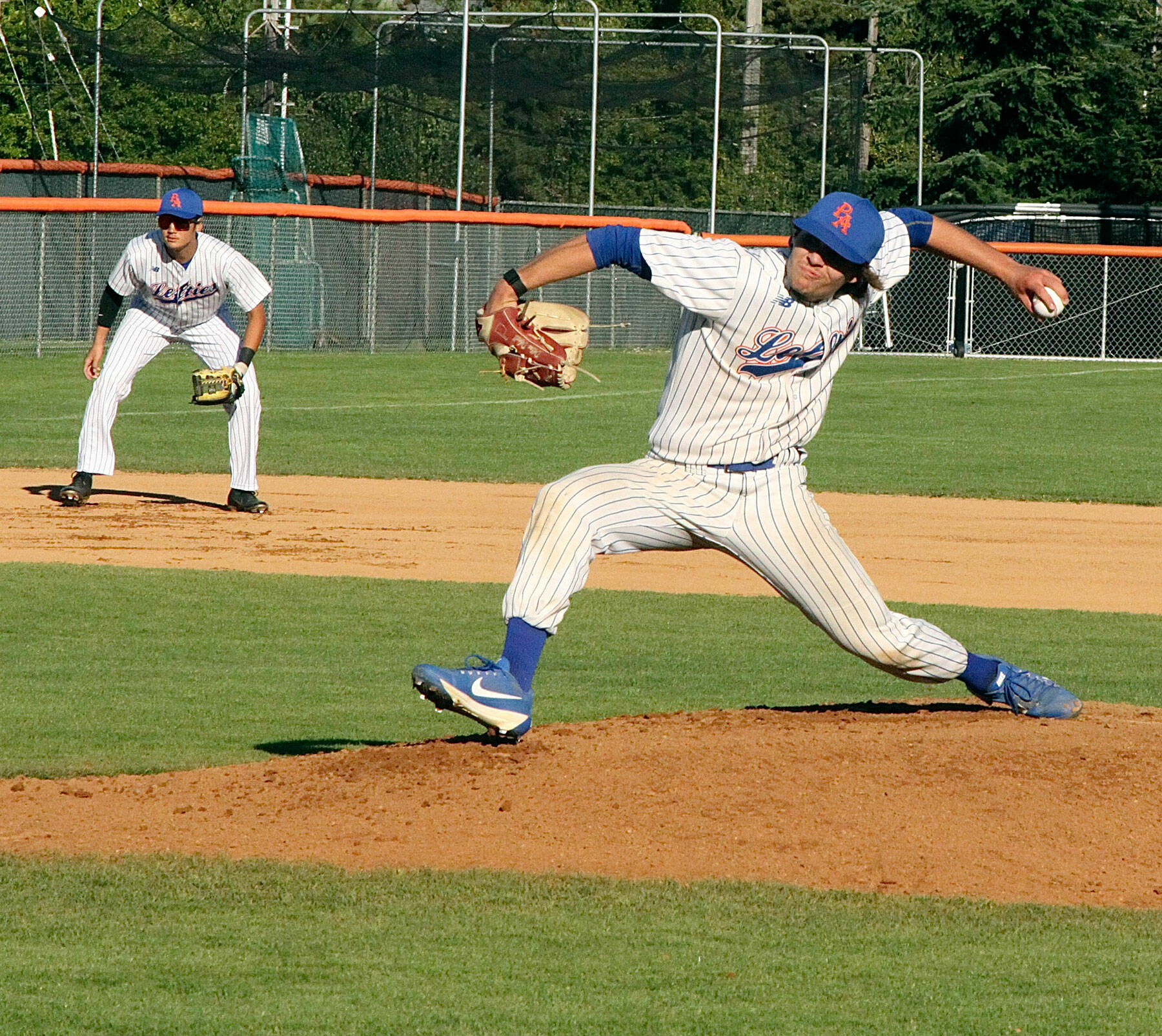 Dillon Dibrell of the PA Lefties fires in a fast pitch to the batter from Kamloops Northpaws. He is backed up by his 3rd baseman B.Y. Choi. dlogan
