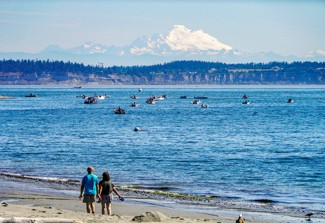 Mount Baker shines in morning sunshine last week as dozens of fishermen try their luck in the waters off the Point Wilson Lighthouse. Fishing is also open this week from Thursday through Saturday. (Steve Mullensky/for Peninsula Daily News)