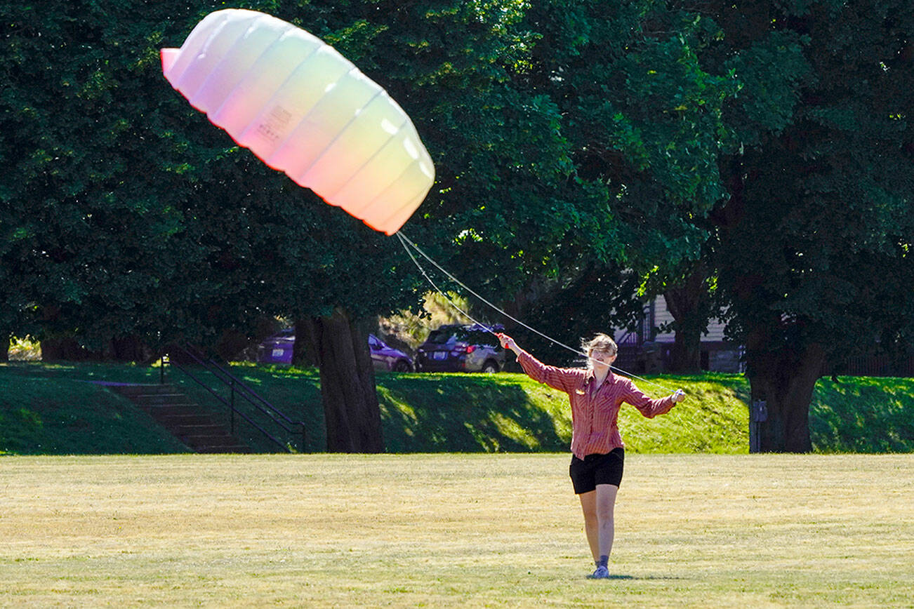 Steve Mullensky/for Peninsula Daily News


Amelia Grant, from Port Townsend, loses air in the canopy of the high performance kite she was flying on the parade ground at Fort Worden State Park on Tuesday. A brisk wind blew in from the west and made for perfect kite flying weather.