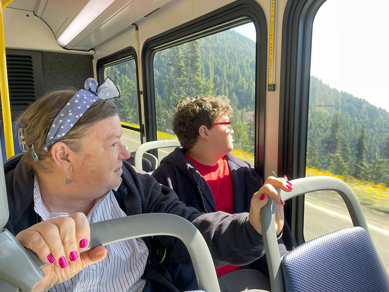 Jeannie Thompson, left, of Livonia, Mich., has visited Hurricane Ridge many times over the years, but says she loves the idea of taking the shuttle rather than driving. This was her 14-year-old grandson Sherman Thompson’s first trip to Port Angeles and Hurricane Ridge. (Paula Hunt/Peninsula Daily News)