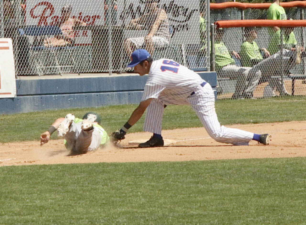 Lefties’ third baseman BY Choi, tags out Yakima Valley baserunner Spencer Shipman who wandered too far off third. Choi took the snap throw from catcher Danny Briones. (Dave Logan/for Peninsula Daily News)
