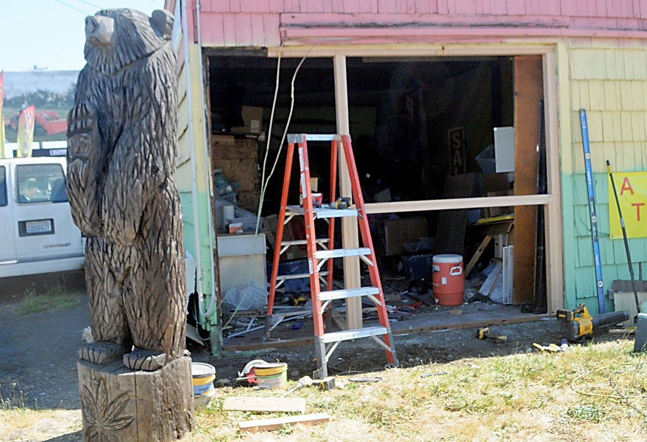 A gaping hole opens the side of a smoke and paraphernalia shop near U.S Highway 101 and Mount Pleasant Road after it was struck by a vehicle Tuesday morning. (Keith Thorpe/Peninsula Daily News)