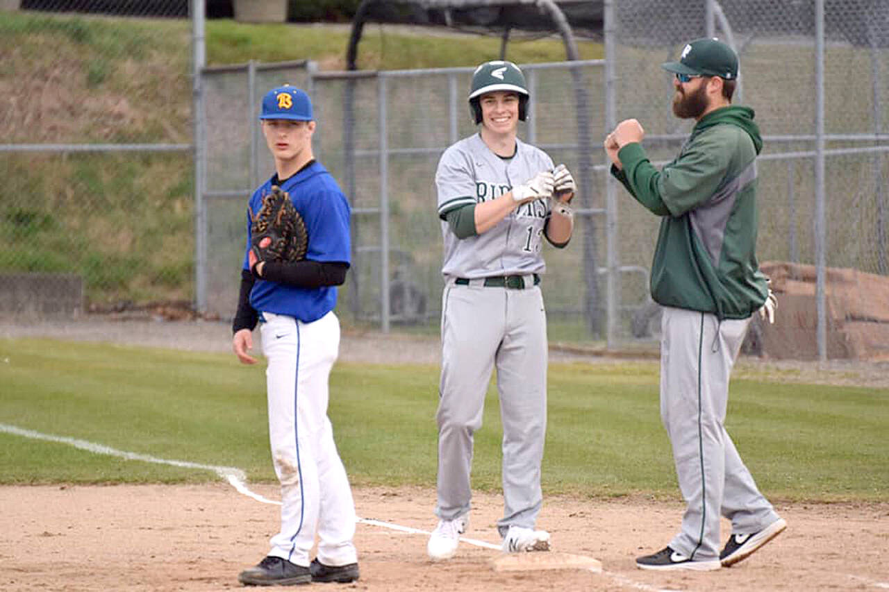 Port Angeles head baseball coach Casey Dietz congratulates Gavin Guerrero after reaching base in a 2019 game against Bremerton. Dietz has resigned from the position after posting a 23-15 record, 18-9 in Olympic League play in two seasons as head coach. (Port Angeles Baseball)