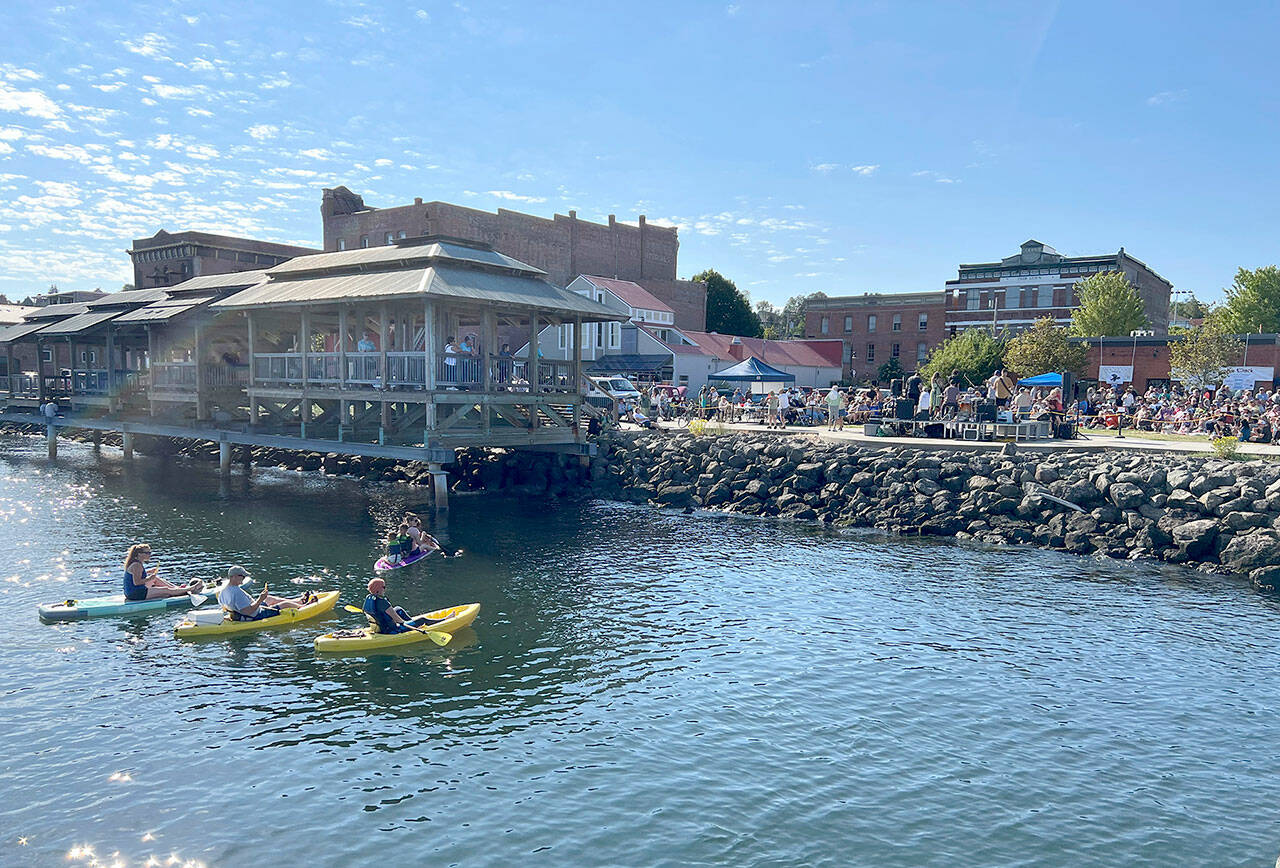 Kayakers find a cool way to beat the heat and listen to live music during Thursday’s Concert on the Dock at Pope Marine Park in Port Townsend. (Steve Mullensky/for Peninsula Daily News)