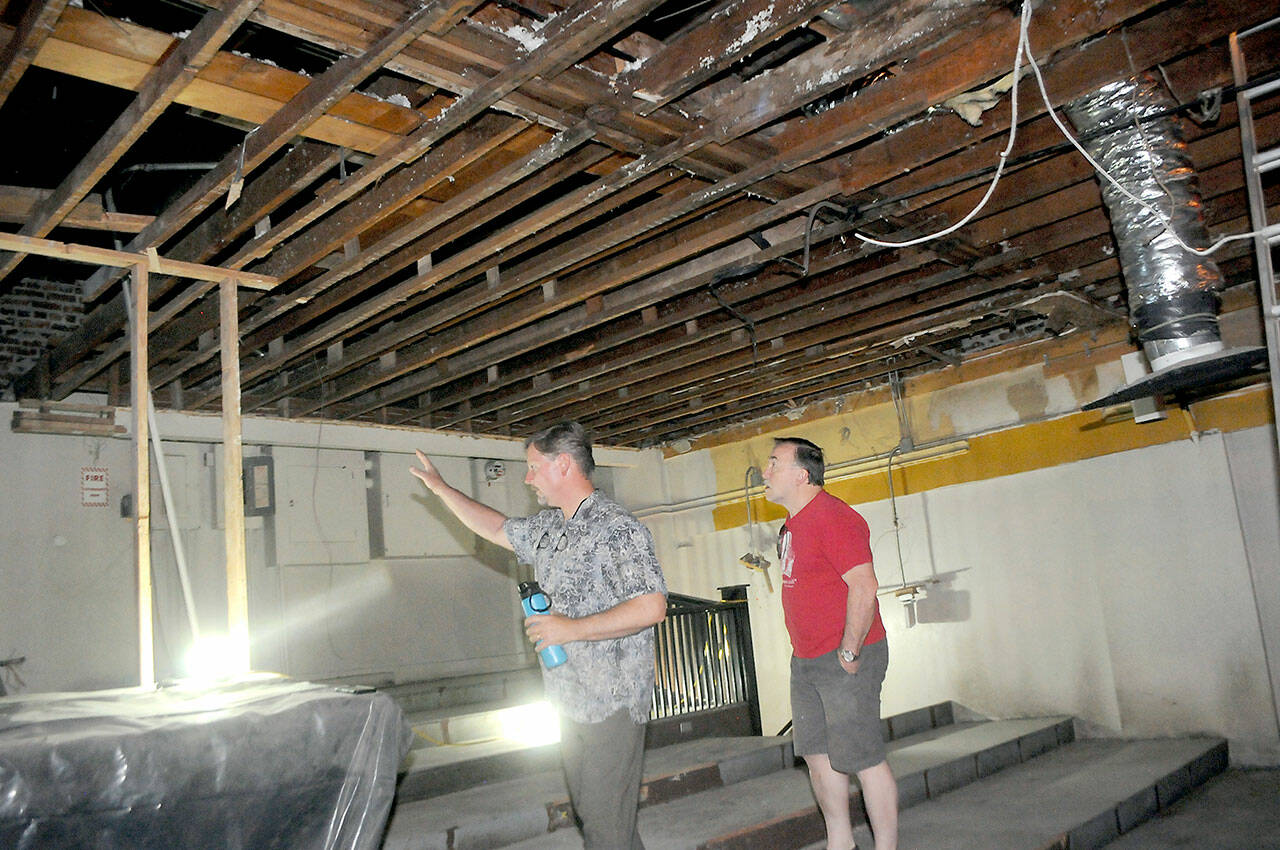 Lincoln Theater co-owner Marty Marchant, left, and Ron Graham, president of Ghostlight Productions, examine the recently uncovered ceiling of the theater’s balcony area on Saturday in Port Angeles. (Keith Thorpe/Peninsula Daily News)