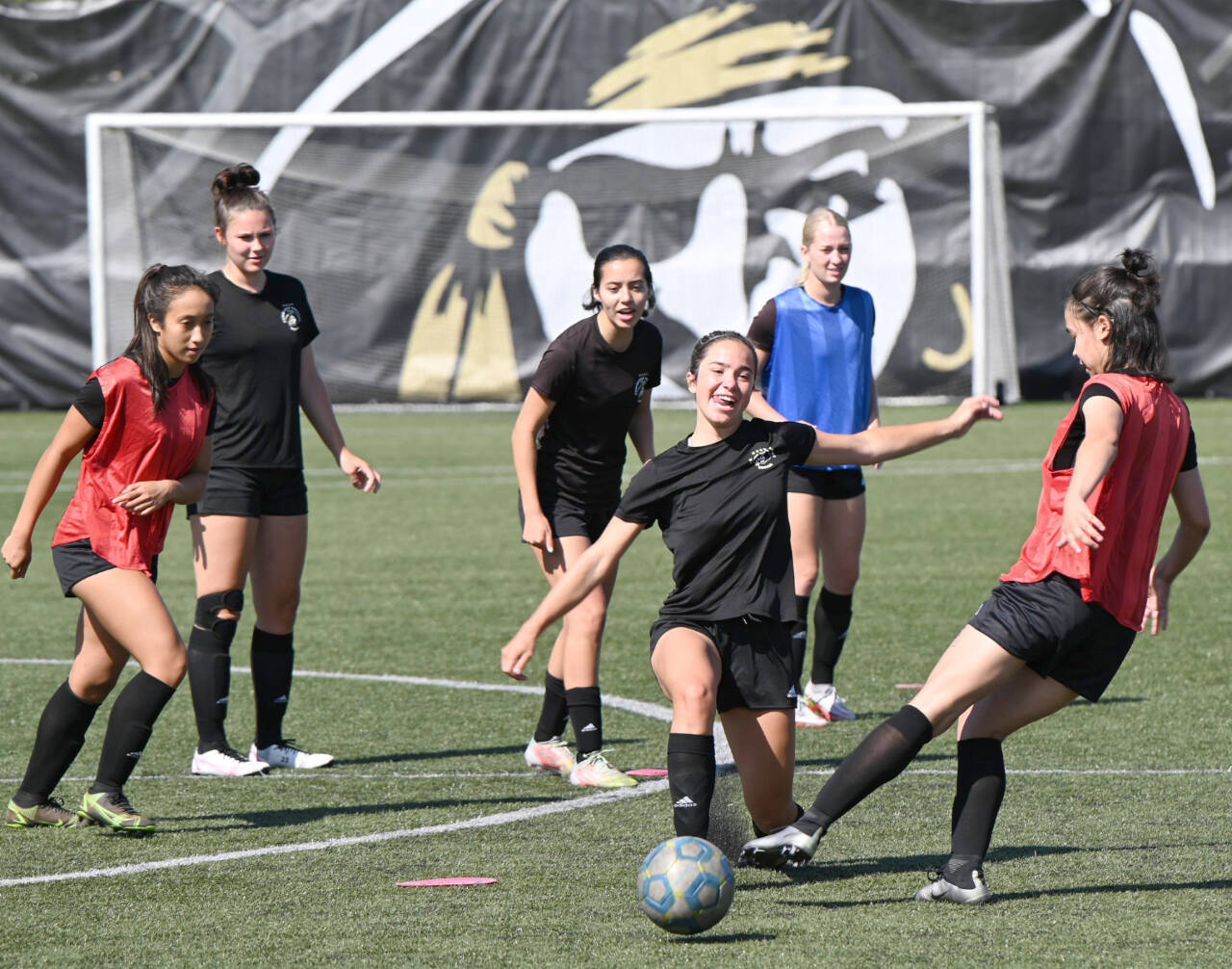 The defending NWAC champion Peninsula College women’s team got on the field for the first time this summer Monday for its first practice of the season. From left in the back are Pirates Breana-Jean Tanaka, Jordyn Newman, Kira Meechudhone and Lexi Harris. Battling over the ball are Riley Sims, left, and Blake Plummer. (Photos courtesy of Peninsula College)