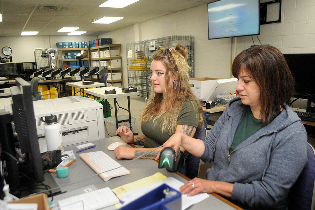 Clallam County Elections Assistant Aspen Smith, left, and Elections Manager Susan Johnson examine contested ballots on Tuesday at the Clallam County Courthouse. (Keith Thorpe/Peninsula Daily News)