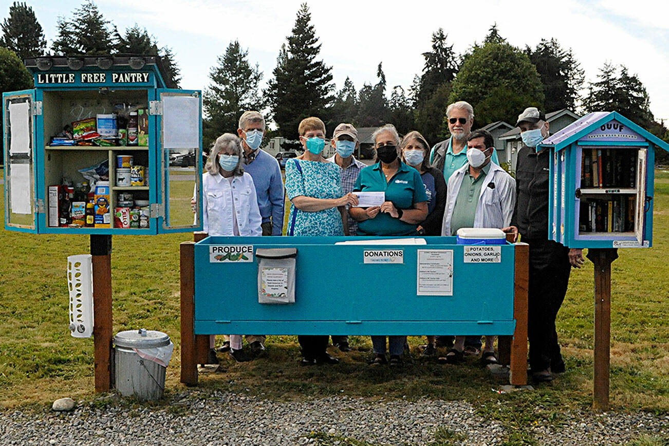 Matthew Nash/Olympic Peninsula News Group 

Agnew Little Free Pantry volunteers greet Sarah Irish, a Molina Healthcare community engagement specialist, fifth from left, as she donates $2,000 for food from the agency. Some of the volunteers who work daily to restock the pantry, include, from left, Susan Harris, Dave Large, Florence and Michael Bucierka, Irish, Peggy and John Toppenberg, Dave Iezzi, and Ren Garypie. 

^