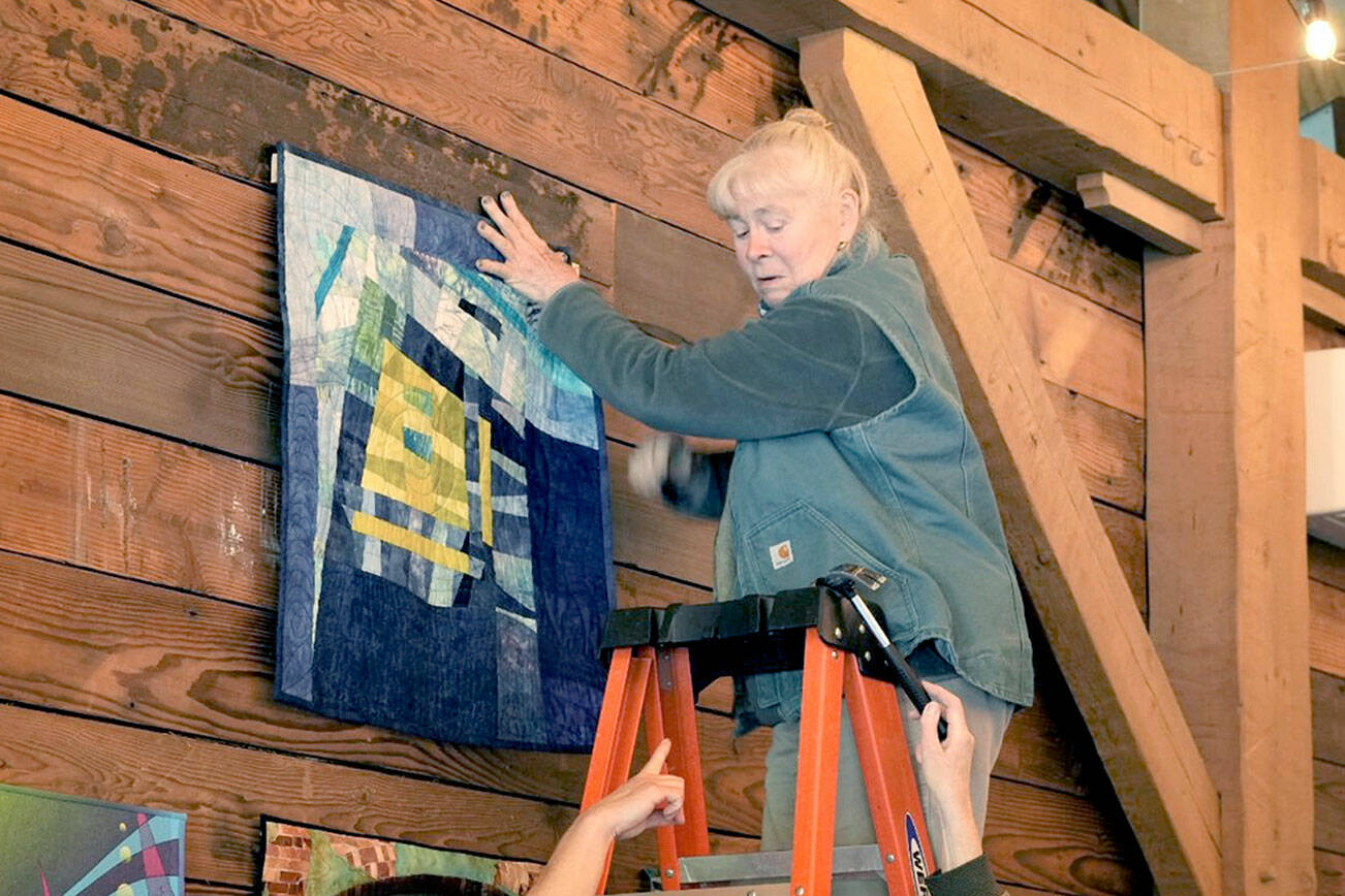 Erica Iseminger of Chimacum, on the ladder, hangs a piece at the Mead Werks with help from, from left. Erika Wurm of Port Townsend, Jeri Auty, of Port Ludlow and Caryl Fallert-Gentry of Port Townsend.  The exhibit of work by Peninsula Fiber Artists, "Anything Goes,”opens today at the Mead Werks at Wilderbee Farm.  It includes artists from Port Townsend, Port Ludlow, Chimacum, Bainbridge Island and Sequim. It is open Saturdays and Sundays from noon to 5 p.m. at 223 Cook Ave Ext., Port Townsend.