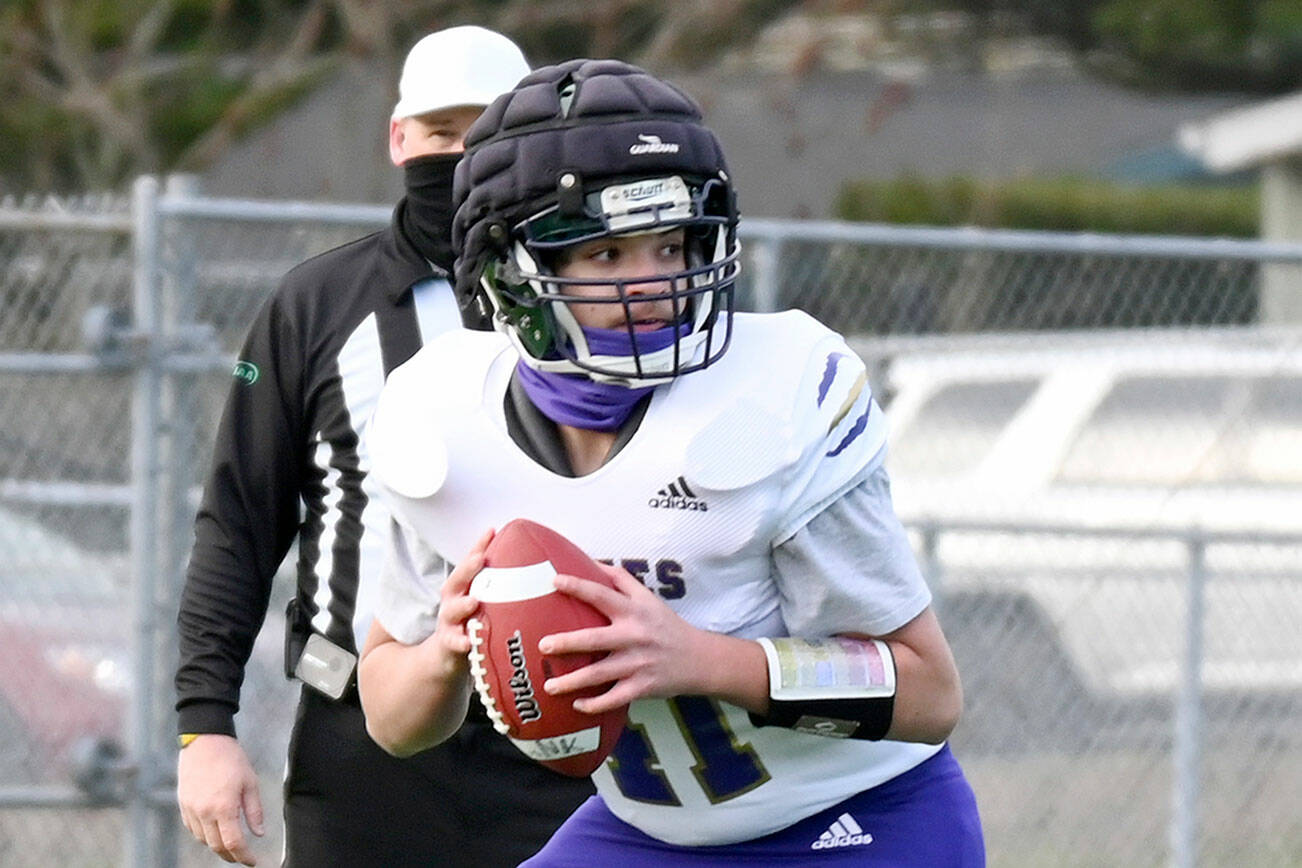 Sequim quarterback Lars Wiker wears a Guardian Cap during a spring 2021 game at North Kitsap. The Wolves have worn Guardian Caps in practice for a number of seasons. The NFL is requiring players to wear the caps during training camp to reduce potential impacts to players' brains.
