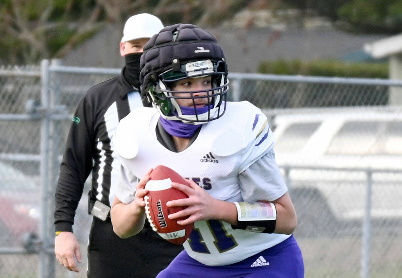 Sequim quarterback Lars Wiker wears a Guardian Cap during a spring 2021 game at North Kitsap. The Wolves have worn Guardian Caps in practice for a number of seasons. The NFL is requiring players to wear the caps during training camp to reduce potential impacts to players’ brains. (Michael Dashiell/Olympic Peninsula News Group)