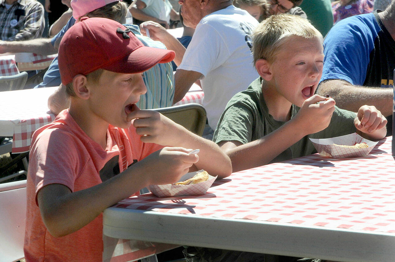 Carson Grooms, 9, left, and brother Kaleb Grooms, 11, both of Joyce, eat pie at Saturday’s Joyce Daze festival. (Keith Thorpe/Peninsula Daily News)