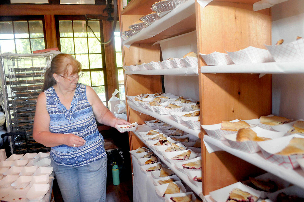 Cheryl Anderson of Joyce stages slices of blackberry pie for sale to the public at the Joyce Daze Wild Blackberry Festival on Saturday in Joyce. (Keith Thorpe/Peninsula Daily News)
