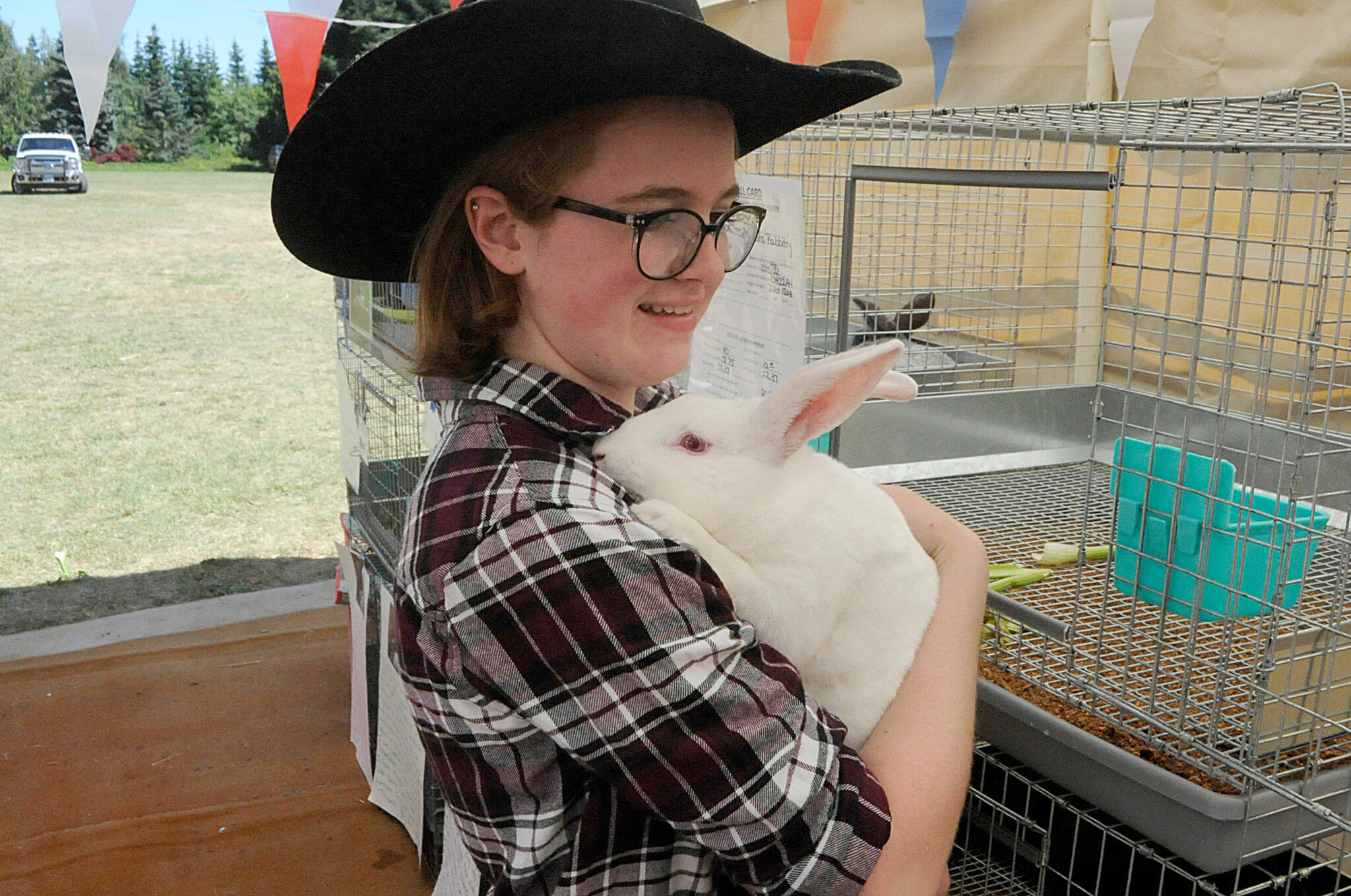 Matthew Nash / Olympic Peninsula News Group
Haley Petty, 17, of Agnew earned reserve market champion with Roast the rabbit at the Clallam County Junior Livestock Auction on Saturday at the Sequim Prairie Grange. It was her fifth year selling animals at the auction.