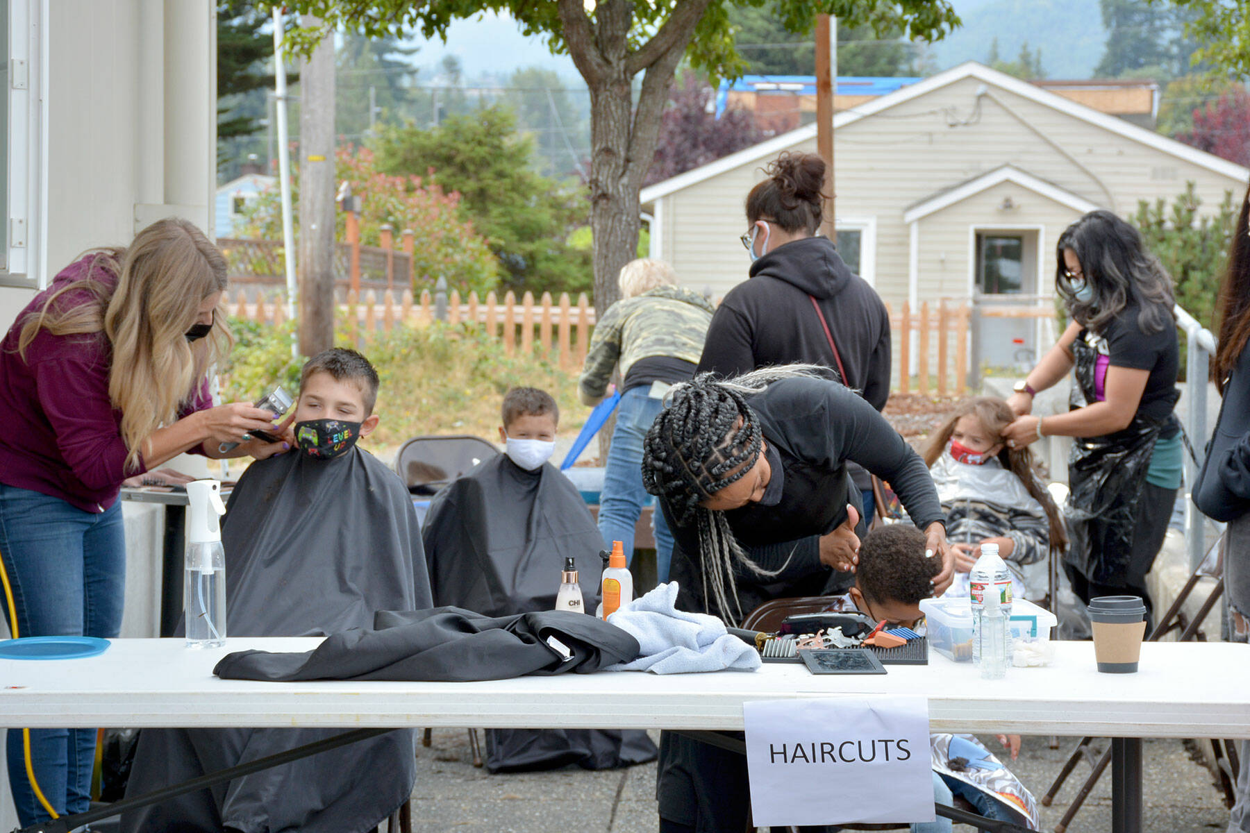 Hair stylists cut students’ hair during the 2021 Back to School Fair.
