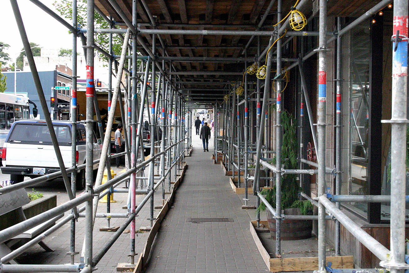 Keith Thorpe/Peninsula Daily News
Scaffolding covers a section of the sidewalk in the 100 block of West First Street to support workers as they upgrade the the facade on Lee Plaza.