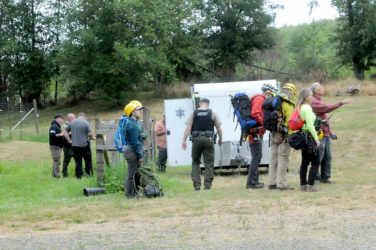 A Jefferson County Search and Rescue team waits at a Jefferson County Sheriff’s Office command post as plans are developed to access the site of a plane crash on Wednesday southwest of Gardiner. (Keith Thorpe/Peninsula Daily News)