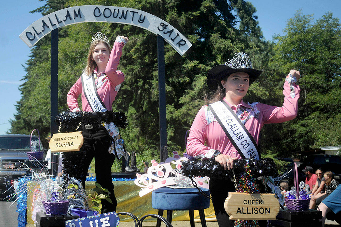 Keith Thorpe/Peninsula Daily News
Fair Queen Allison Pettit, front, and Queen's Court Sophia Lawson, shown on Aug. 6 on their parade float in the Joyce Daze Wild Blackberry Festival, will preside over the Clallam County Fair starting on Thursday in Port Angeles.