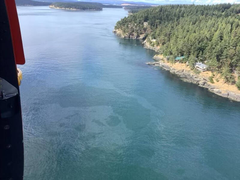 An aerial photo released Saturday by the U.S. Coast Guard shows a diesel spill off the west coast of San Juan Island after a 49-foot fishing vessel sank with an estimated 2,600 gallons of fuel on board. A Good Samaritan rescued all five crew members on the Aleutian Isle as the vessel was sinking near Sunset Point, the Coast Guard’s 13th District Pacific Northwest district in Seattle and KIRO-TV reported. (U.S. Coast Guard via The Associated Press)