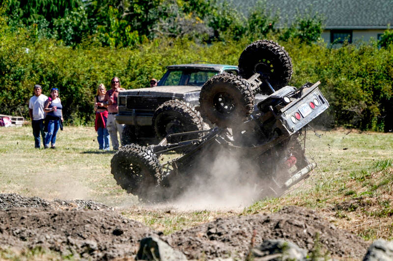 Steve Short of Port Townsend escaped without a scratch after he rolled his 1987 Suzuki Samurai during a run on the 4x4 course at the Jefferson County Fair on Sunday. Short said he should have “rolled back, but my foot slipped off the brake pedal and hit the gas instead.” The vehicle sustained damage to the front end, but it smoked a lot on the way back to the pits. (Steve Mullensky/for Peninsula Daily News)