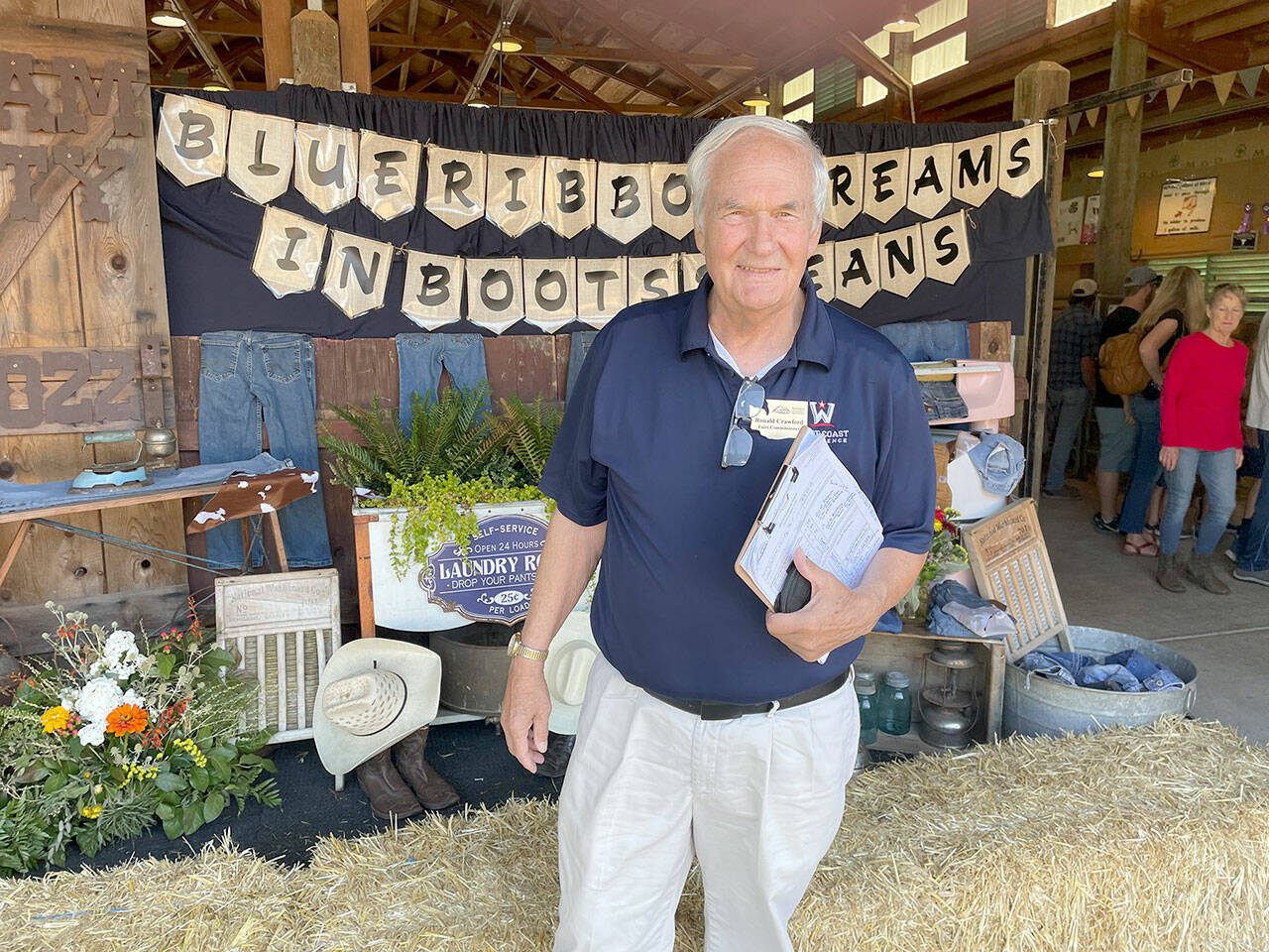 Ron Crawford, one of seven Washington State Fair commissioners, visited the Clallam County Fair on Saturday to evaluate it in a wide range of categories from the quality of its livestock and agricultural exhibits to cleanliness to the education value of displays. (Paula Hunt/Peninsula Daily News)