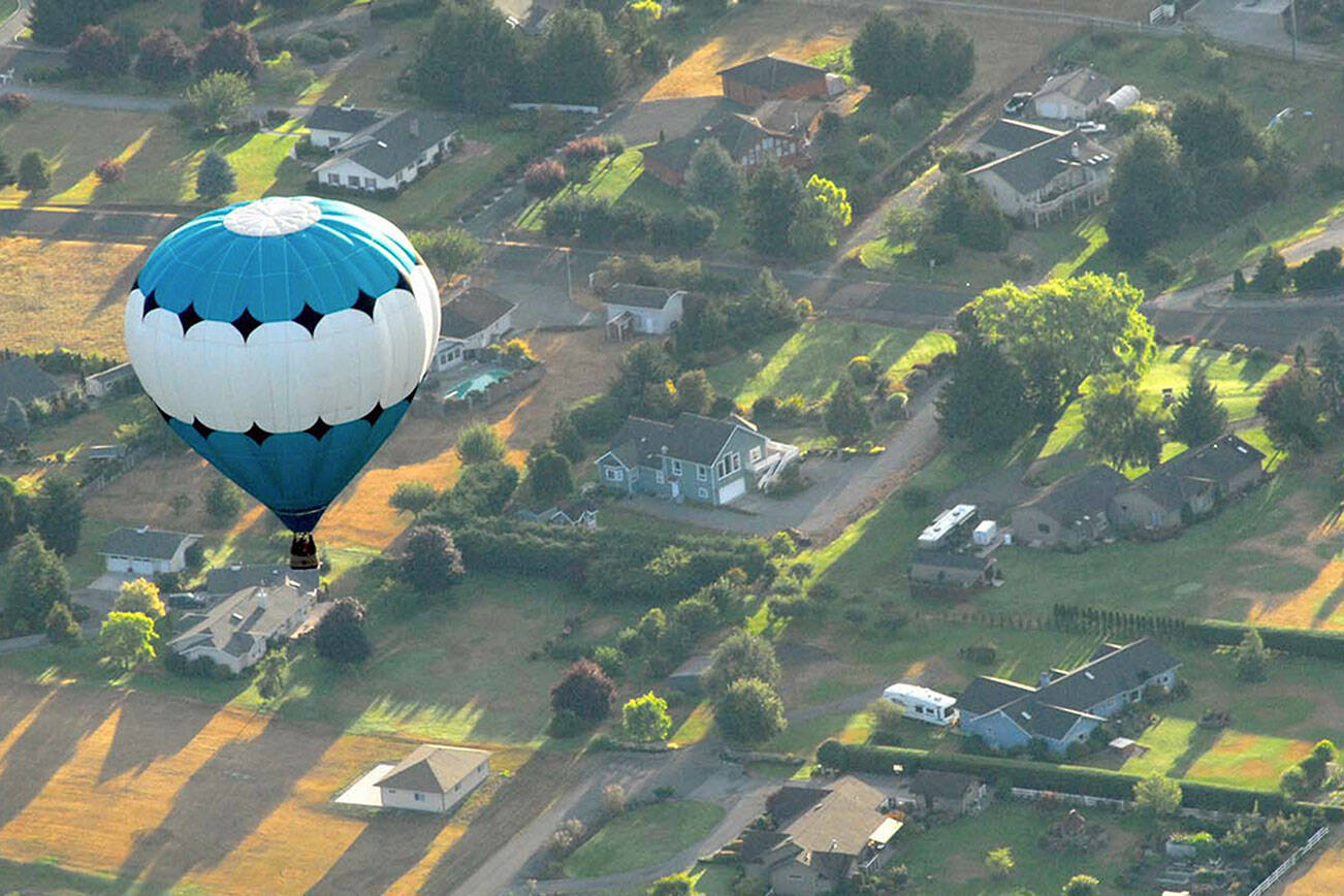A hot air balloon piloted by Captain Crystal Stout drifts over the Dungeness Valley west of Sequim in this 2012 file photo. (Keith Thorpe/Peninsula Daily News)