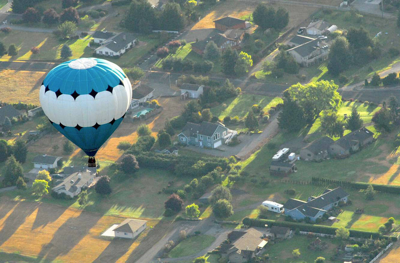 A hot air balloon piloted by Captain Crystal Stout drifts over the Dungeness Valley west of Sequim in this 2012 file photo. (Keith Thorpe/Peninsula Daily News)