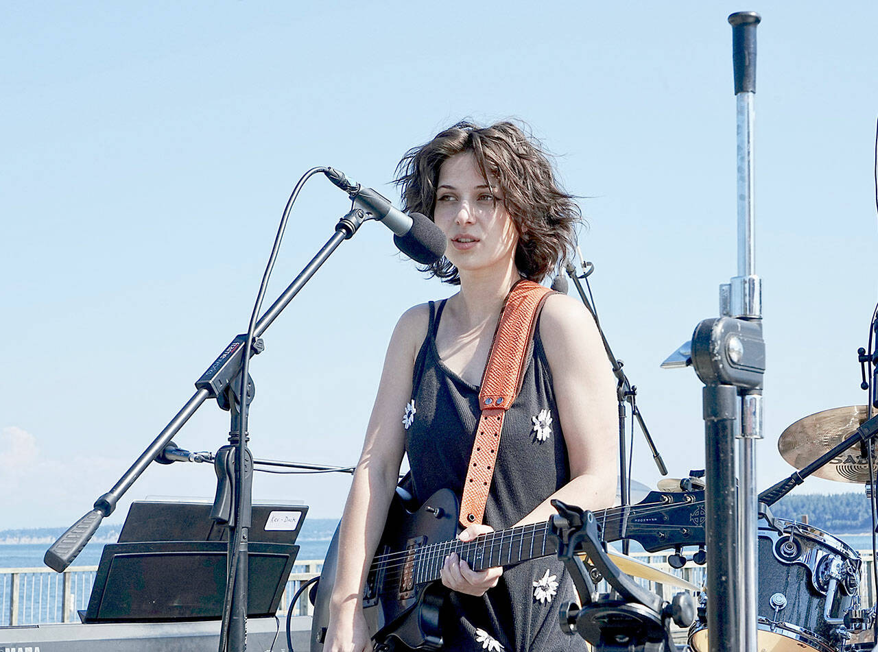 Port Ludlow’s Mia Torres, 20, performs six of her original songs during the Concerts on the Dock on Thursday at Pope Marine Park in Port Townsend. The performance was part of the grand finale of free outdoor summer concerts. Port Townsend Main Street and Soundcheck joined forces, with live music beginning at 2 p.m. and continuing into the evening. (Steve Mullensky/for Peninsula Daily News)