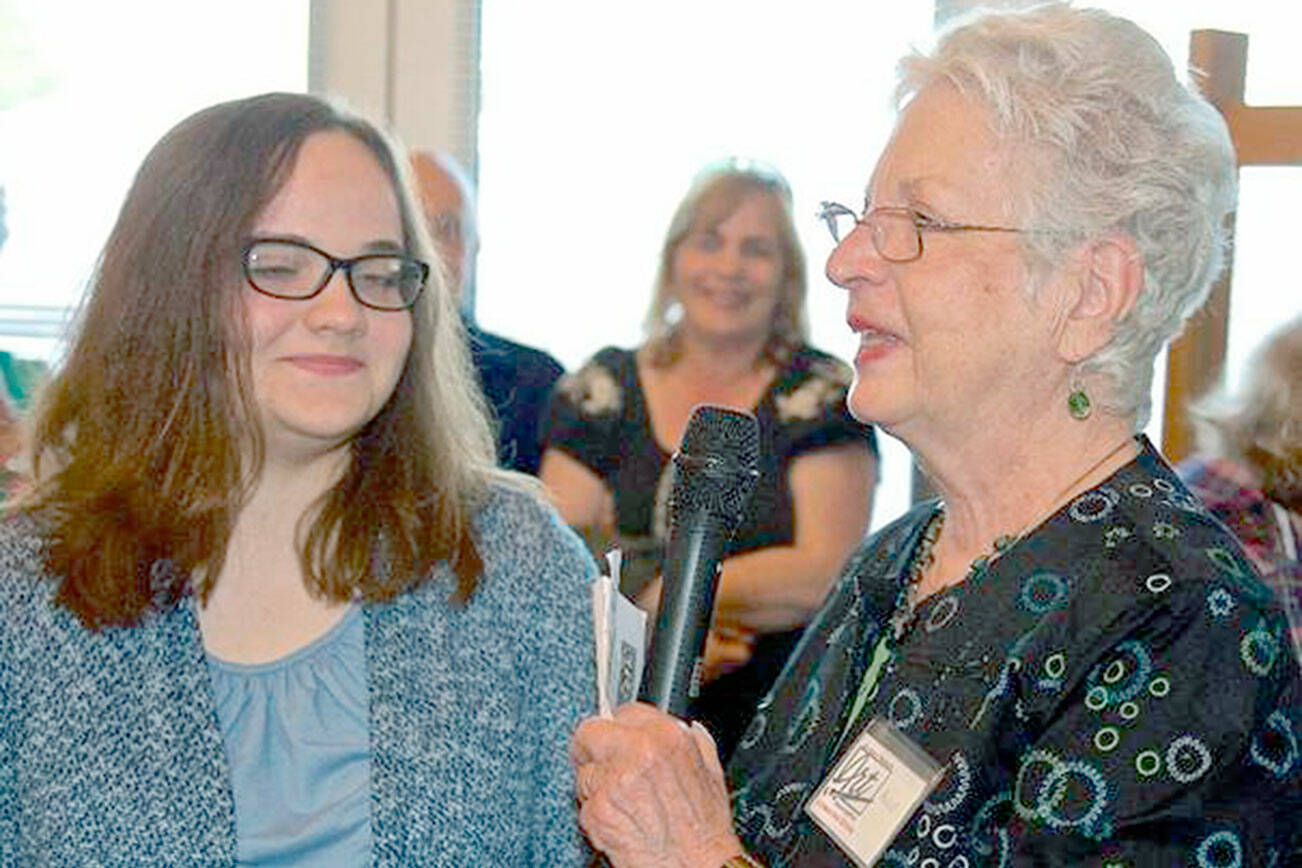 Amanda Wiggins (left) receives the 2019 youth scholarship from Anne Grasteit, Olympic Peninsula Art Association president, at OPAA's 50th anniversary celebration.  A donation from Peninsula ART Friends exhibit proceeds will go to support OPAA's scholarship.
