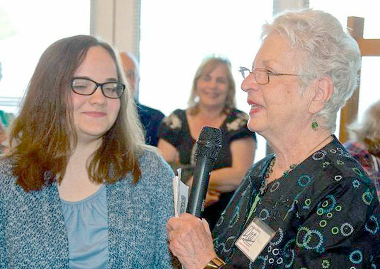 Amanda Wiggins (left) receives the 2019 youth scholarship from Anne Grasteit, Olympic Peninsula Art Association president, at OPAAs 50th anniversary celebration. A donation from Peninsula ART Friends exhibit proceeds will go to support OPAAs scholarship.
