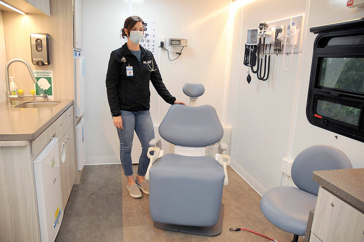 Maria Melvin, an advanced registered nurse practitioner for the North Olympic Healthcare Network, stands in the examination room of the organization’s mobile health clinic during a session at Port Angeles High School. (Keith Thorpe/Peninsula Daily News)