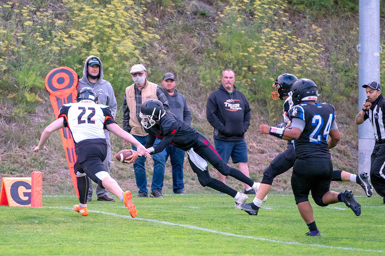 Steve Mullensky/for Peninsula Daily News


Granite Falls Tiger, Connor Wichman, (11) can only watch as East Jefferson Rival, Cash Holmes, dives into the end zone for six points after a 10 yard dash from scrimmage during a Friday night game in Port Townsend’s Memorial Field.