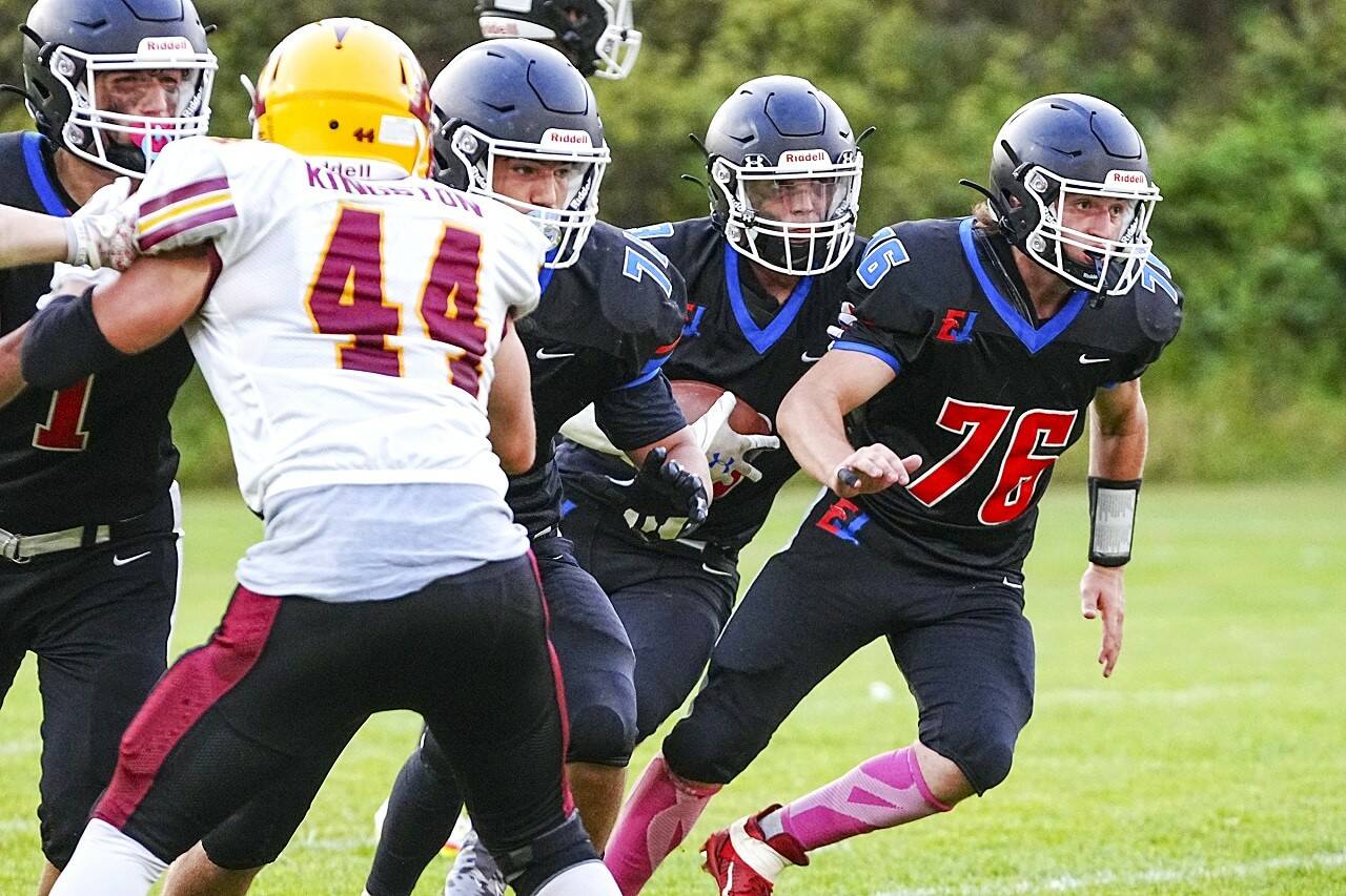The Rivals’ Gary Zambor (1) holds off Kingston’s Aaron Fitsemons (44), as Charly Schweitzer (78) and Sean Jones (76) provide protection for quarterback Cash Holmes, during a game against the Kingston Buccaneers on Friday at Memorial Field in Port Townsend. (Steve Mullensky/for Peninsula Daily News)