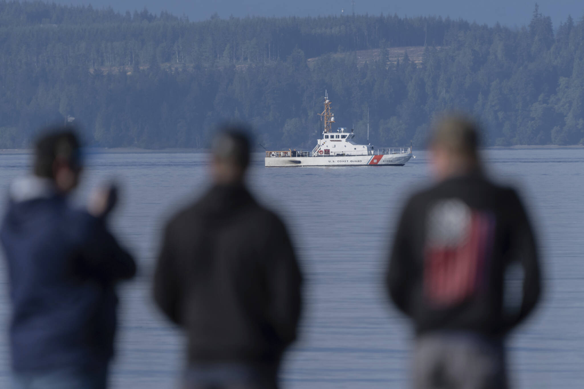 A U.S. Coast Guard vessel searches the area Monday near Freeland on Whidbey Island north of Seattle, where a chartered floatplane crashed the day before. The plane was en route from Friday Harbor to Renton. (Stephen Brashear/The Associated Press)